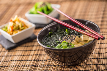 Traditional japanese soup Miso with tofu seaweed chopsticks and young onion