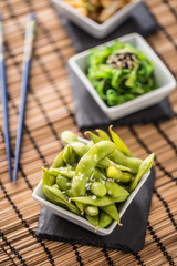 Japanese asian food edamame nibbles, boiled green soy beans.