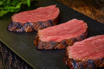Sous-vide steak cut into pieces, cooked to eat beef on the stone table