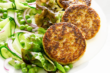 green salad with fish cutlets and mayo sauce