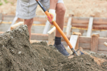 A worker works a shovel.