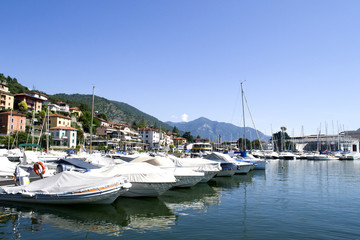 Fototapeta na wymiar Lake with boats on the water. Beautiful landscape in Italy with boats on the water.