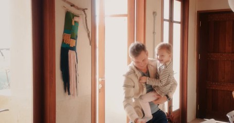 Happy little daughters welcoming father home from work