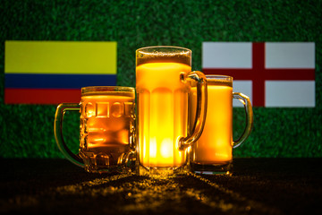 Soccer 2018. Creative concept. Beer glasses on grass. Support your country with beer concept.