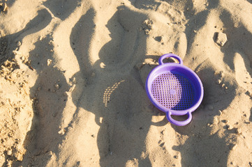 Children's toy on the surface of sand.