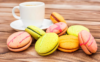 Colorful macaroons and cup of coffee on the table.