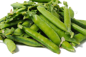 Young green peas in sticks on a white background. Front view.