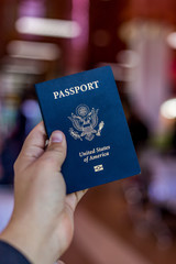 A hand holding and American passport