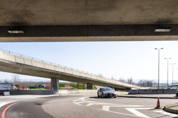 Modern electric car in urban concrete landscape