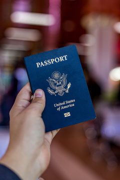 A Hand Holding And American Passport