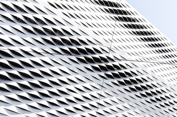 Abstract regular wavy pattern in silver steel sheet cladding