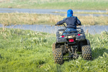 The boy is traveling on an ATV. © Ахтем