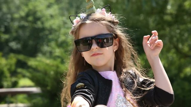 Little girl shoots from a slingshot