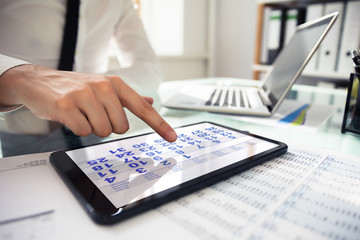 Businessperson Using Calendar On Digital Tablet