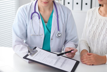 Doctor and patient, close-up of hands.  Physician talking about medical examination results....