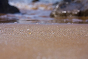 Fototapeta na wymiar waves beach wind stones