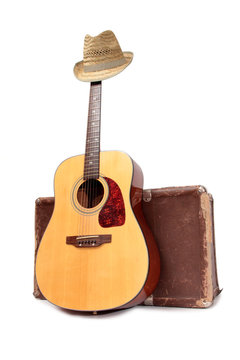 Old suitcase and guitar in country style on a white background