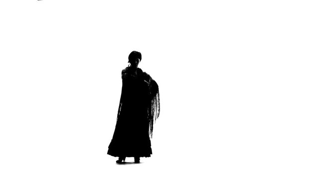 Girl is dancing with a manton in her hands. White background. Silhouette