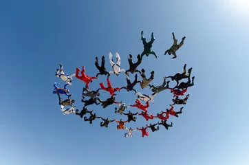 Fototapeten Skydiving group formation low angle view © Mauricio G