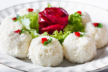Sharp cheese with coconut flakes, with  rose from beet