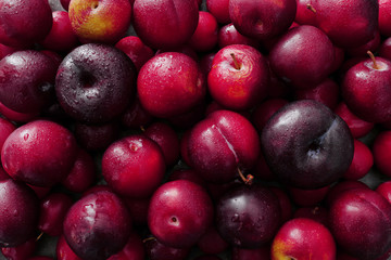 Ripe juicy plums as background