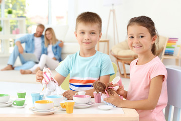 Cute little brother and sister playing at home