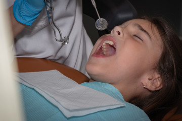 background. girl at the reception at the dentist. preparation of work with a cofferdam. professional dentistry