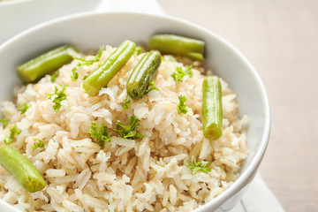 Brown rice with green beans in bowl, closeup