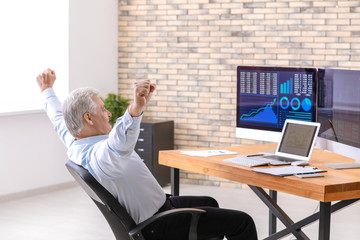 Male broker working in office. Finance trading concept