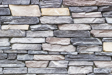 front wide shot of highlighted masonry rectangle colorful stone wall in Izmir at Turkey with traditional stucco