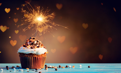 Chocolate Cupcake With Sparkler And Hearts Of Lights
 - obrazy, fototapety, plakaty