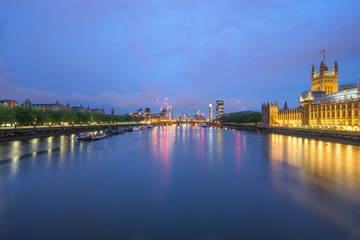 Fototapeta na wymiar River Thames partly overlooking Wesminster palace at dawn in London. England