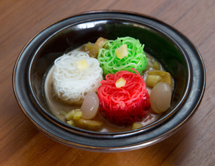 Red, green and white rice noodles in the bowl