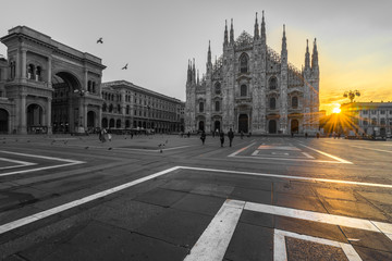 Fototapeta na wymiar Duomo cathedral in black and white with yellow sun flare, Milan. Italy 