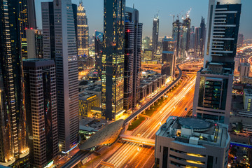 Fototapeta na wymiar Dubai finance district illuminated at dusk, UAE