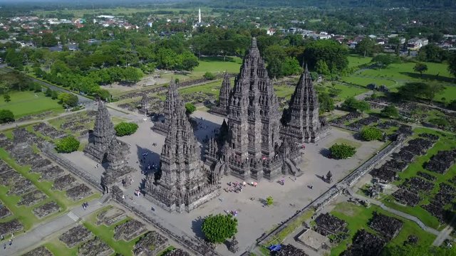 Flying towards Prambanan Hindu temple complex, camera tilting down through the flight, Yogyakarta Indonesia tourism