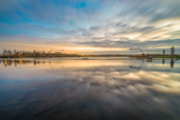 Sunrise at Willen Lake in Milton Keynes, England. Long exposure with blurry sky 