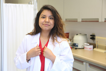 Portrait of a young hispanic female doctor in medical clinic