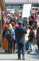 HAKONE, JAPAN - NOVEMBER 5, 2017: A man in uniform with a sign on a city street. Frame for text....