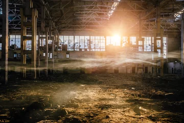 Fototapeten Sonnenlicht des Sonnenuntergangs in einem großen verlassenen Industriegebäude der Baggerfabrik in Woronesch © Mulderphoto