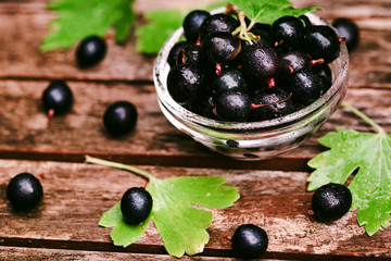 Ripe blackcurrant in glass bowl close