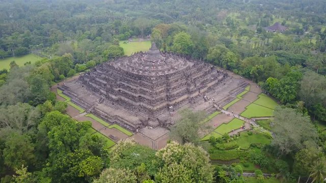 Tilting drone shot of beautiful Borobudur Buddhist temple complex, history and culture in Indonesia
