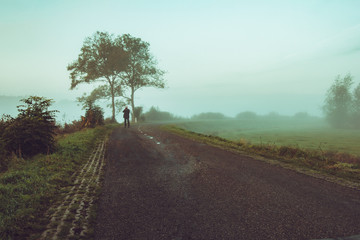 A photographer on the country road early morning