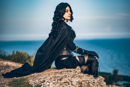 Fantasy cosplay beautiful Witcher girl on cliff