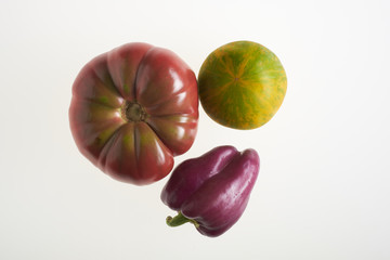 Multicolored tomatoes and purple pepper