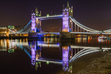 Fototapeta na wymiar Tower Bridge with reflections at night in London