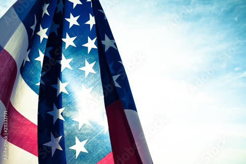 USA Independence day, 4 July. vintage style of Close up United States of America flag on the blue sky background.