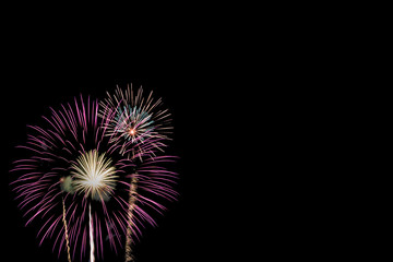 Abstract beautiful colorful fireworks display for celebration on black background with free space...