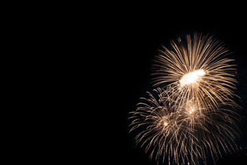 Abstract beautiful colorful fireworks display for celebration on black background with free space...