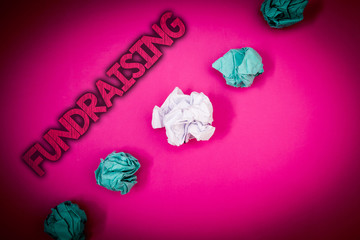 Conceptual hand writing showing Fundraising. Business photo text Seeking of financial support for charity cause or enterprise Ideas messages pink background crumpled papers several tries.